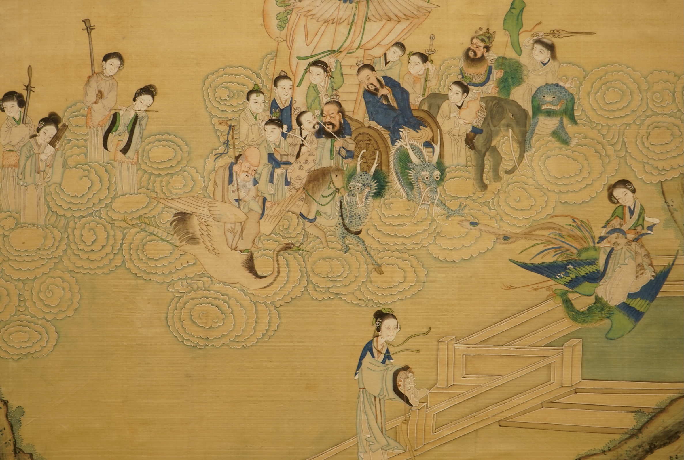 Chinese School (early 20th century), a pair of paintings on silk, Immortals in the heavens including Shou Lao and Xi Wangmu and figures by a lake, 35 x 53cm